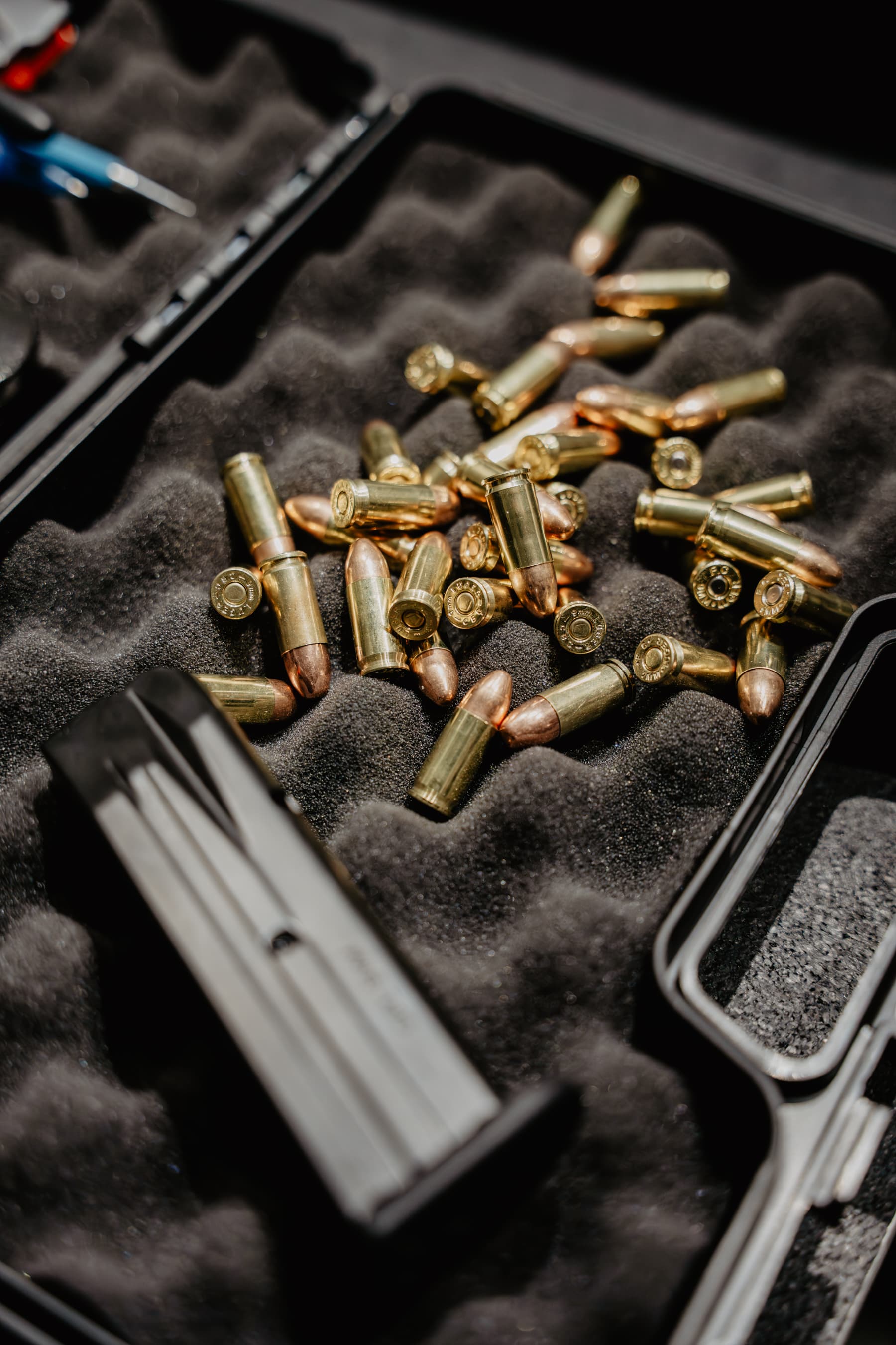 9mm rounds and a pistol magazine in a foam-lined case