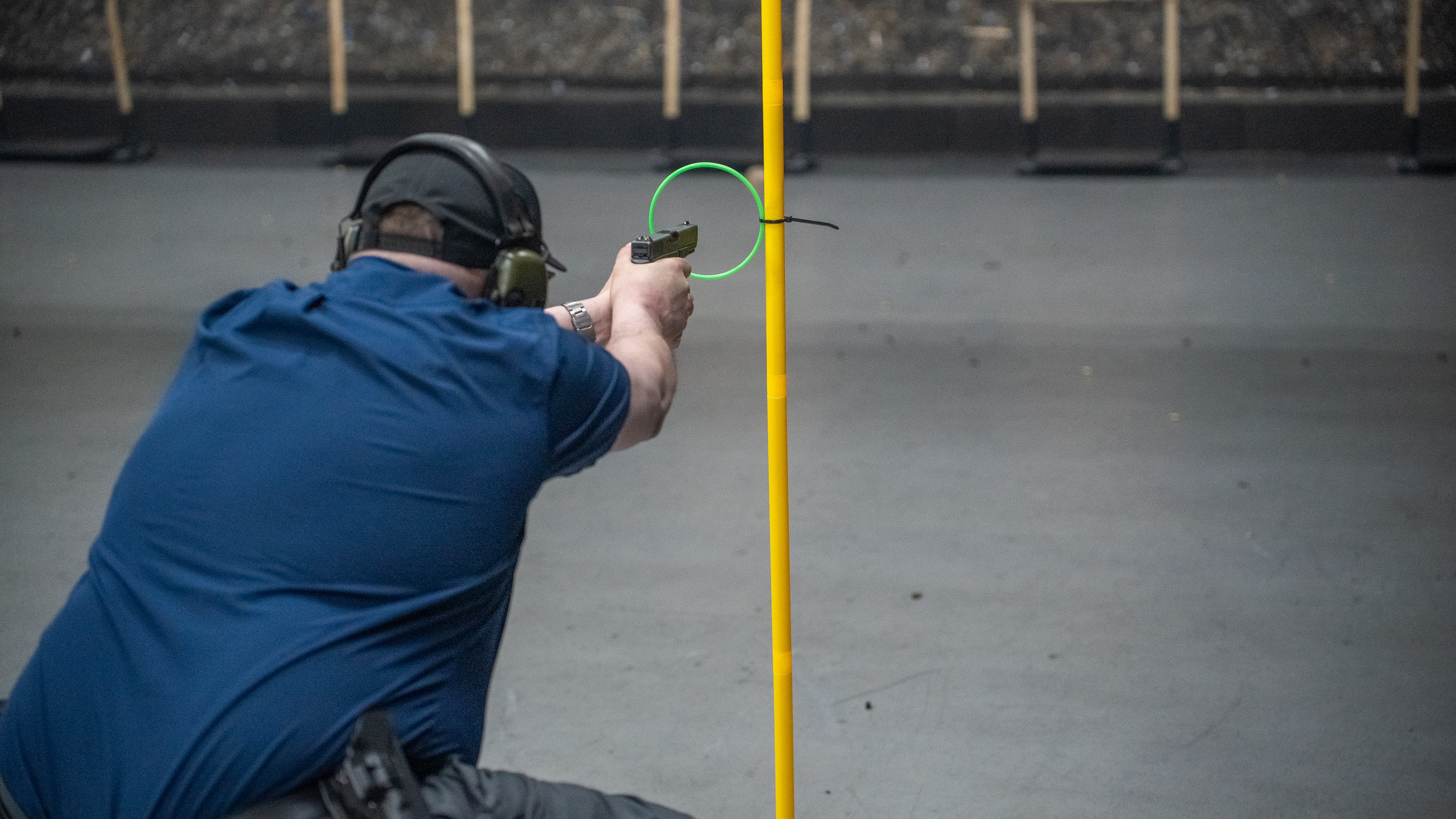 Shooter engaging targets from behind cover during a Pistol & Barricade live-fire drill