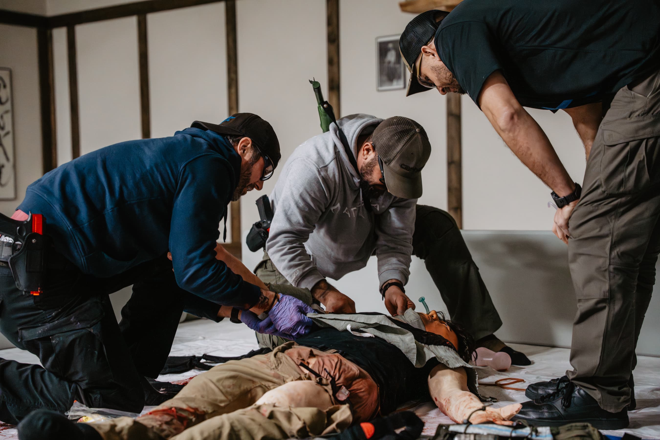 Three students working on a casualty during a tactical medicine drill